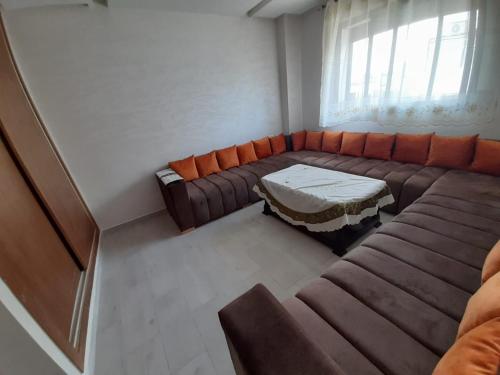 a living room with a couch and a table at Appartement plage Mehdia in Plage de Mehdia