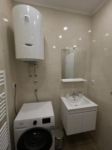a bathroom with a washing machine and a sink at Vista in Trebinje