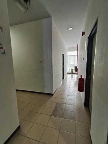 a hallway of an empty room with a fire hydrant at Hotel Wawasan in Simpang Renggam