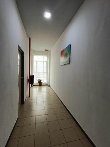 an empty hallway with a painting on the wall at Hotel Wawasan in Simpang Renggam