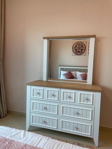 a dresser with a mirror on top of it at One bedroom new brand in ajman in Ajman 