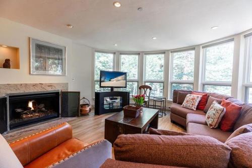 a living room with a couch and a fireplace at Ski In Ski Out condo with Access to Vail Mountain in Vail