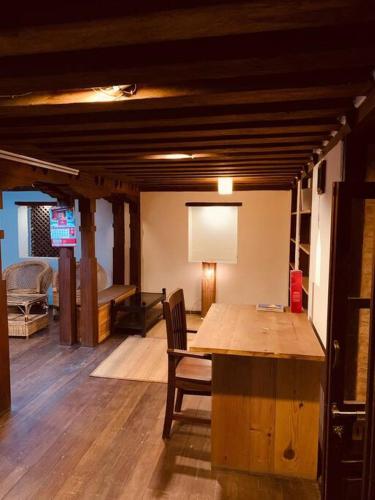 a living room with a wooden table and chairs at Traditional Nepali Style 1 & 2 BHK Apartments, Humble Home, Patan in Pātan