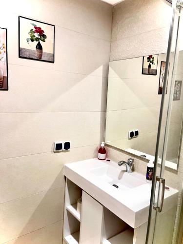 a bathroom with a sink and a mirror at Porte de mer Apartement in Essaouira