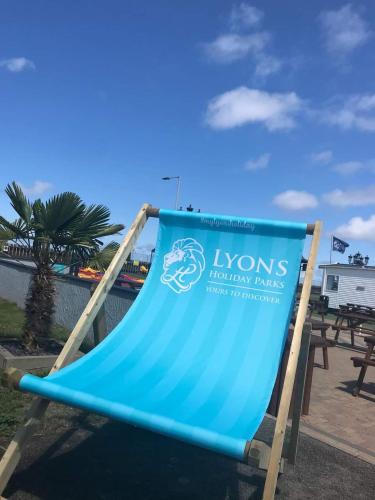 a sign for the lyons lions tennis games at Lucy's Lodge in Rhyl