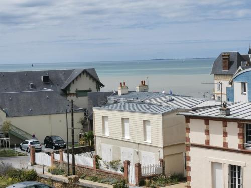 a view of the beach from the roofs of houses at Appartement "La Marine" vue mer in Saint-Pair-sur-Mer
