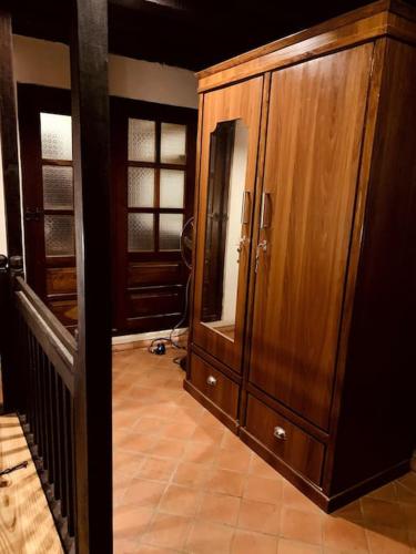 a room with a large wooden cabinet in a house at Traditional Nepali Style 2 BHK Apartments, Humble Home, Patan in Pātan