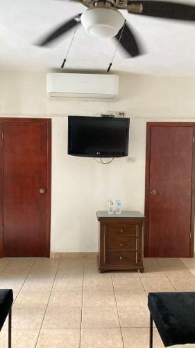 a living room with a flat screen tv on a wall at Mansion Serrano Hotel in El Fuerte