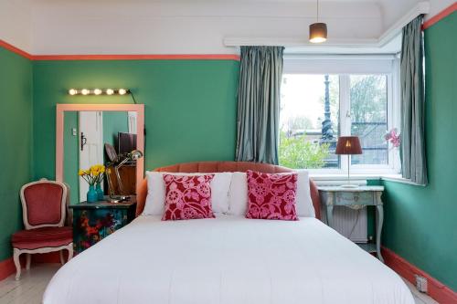 um quarto com uma cama branca e uma janela em Veeve - Highgate High Notes em Londres
