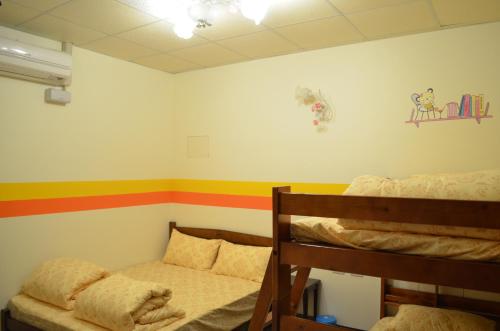 a room with two bunk beds and a rainbow stripe on the wall at 花蓮阿羅國際青年旅舍民宿 in Hualien City