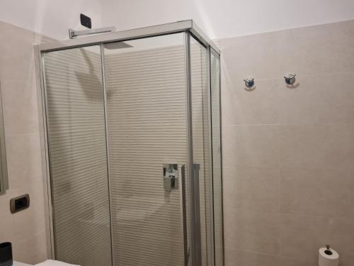 a shower with a glass door in a bathroom at Monti Guest House Alghero in Alghero