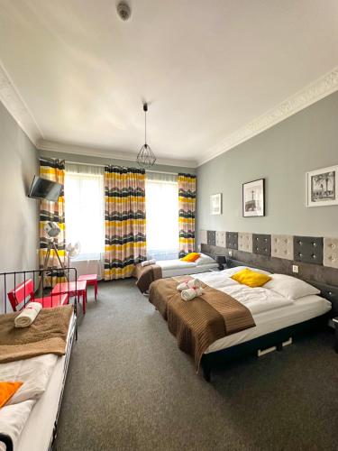 a bedroom with three beds in a room at Expolis Residence - City Center - 24h POZNAŃ GŁÓWNY #betterthanyourEX in Poznań