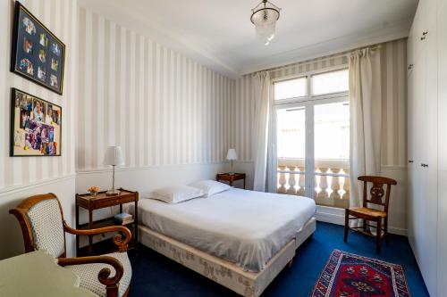 een slaapkamer met een wit bed en een raam bij Veeve - Pérignon's Palazzo in Parijs