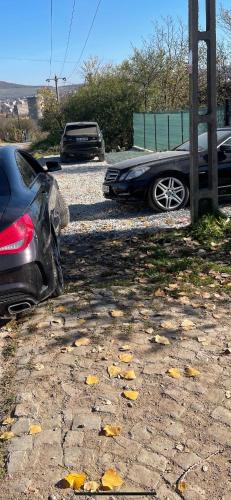two cars are parked in a parking lot at CABANĀ TIP A LA 300 m De CASTEL in Hunedoara