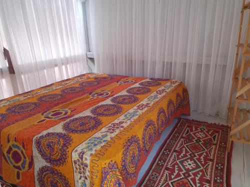 a bedroom with a bed and a rug at Exotic sleeping in the woods near Olbia in Telti
