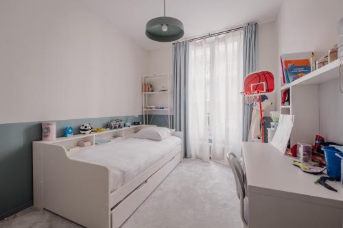 une petite chambre avec un lit et un bureau dans l'établissement Veeve - Sky Dreams, à Paris