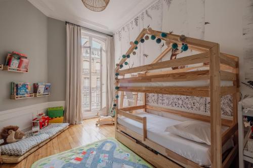 a bedroom with a wooden bunk bed in a room at Veeve - Heavenly Elegance in Paris