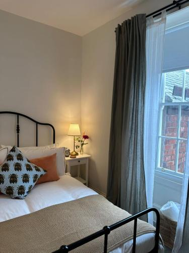 a bedroom with a bed next to a window at The Victoria Hotel,Bar,Bistro in Norham
