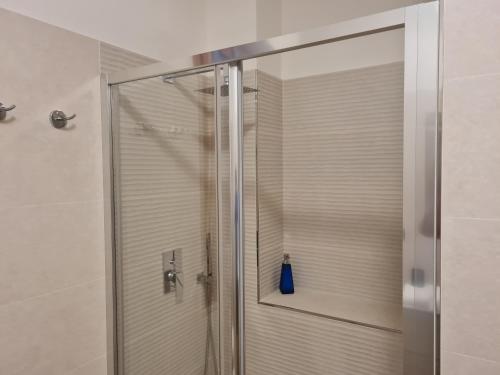 a shower with a glass door in a bathroom at Monti Guest House Alghero in Alghero