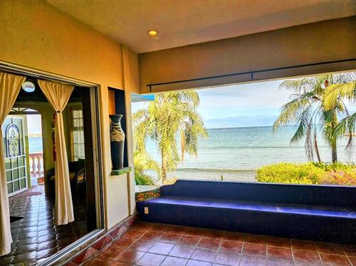 a room with a window with a view of the ocean at Villas Jardin Del Mar in Cruz de Huanacaxtle