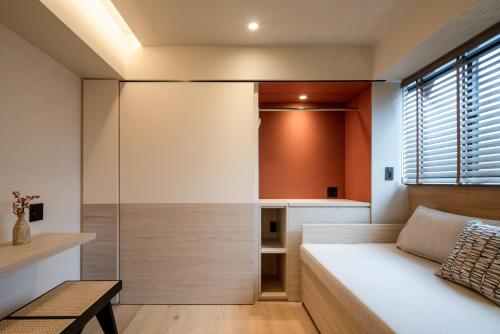 a bedroom with a bed and a glass wall at LiveGRACE Hotel Azabu 麻布芝公園 in Tokyo