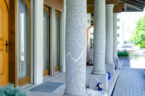 a row of columns in front of a building at Luxuriöse Villa Romantica in Gampel