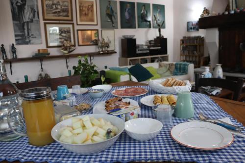 a table with a blue and white table cloth with food on it at GABRY GUEST HOUSE in Bruno