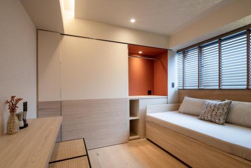 a bedroom with a bed and a window at LiveGRACE Hotel Azabu 麻布芝公園 in Tokyo