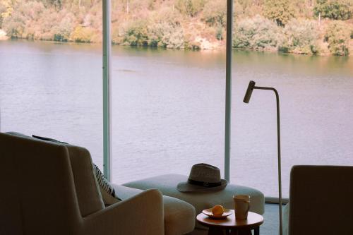 a living room with a view of a large window at Octant Douro in Castelo de Paiva