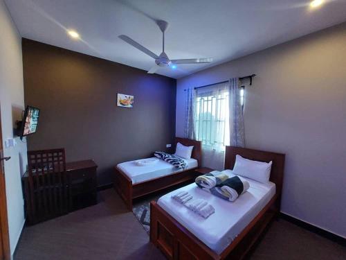een kamer met 2 bedden en een raam bij Kiteme Comfort Lodge in Arusha