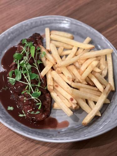 a plate of food with french fries and sauce at Delta Hotels by Marriott Basking Ridge in Basking Ridge