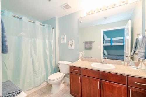 a bathroom with a toilet and a sink and a shower at Laketown Wharf #119 by Nautical Properties in Panama City Beach