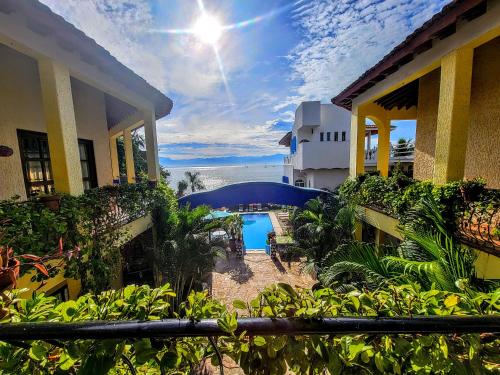a view of a courtyard of a house with a pool at Villas Jardin Del Mar in Cruz de Huanacaxtle