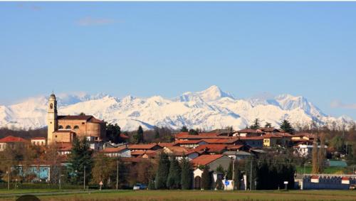 a town with snow covered mountains in the background at Casa Valletta in Mezzomerico