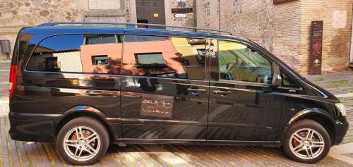 a black van parked on a city street at Entre Dos Aguas Hotel Boutique in Toledo