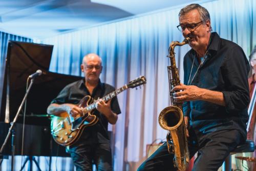 a man playing a saxophone and another man playing a saxophone at Felbermayer Hotel & AlpineSpa-Montafon in Gaschurn