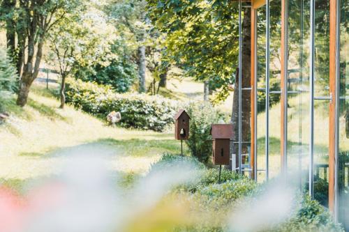 a bird house on a pole in a field at Felbermayer Hotel & AlpineSpa-Montafon in Gaschurn