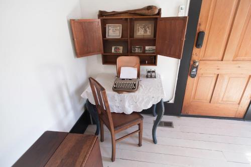 a table with a laptop on it with a chair at Beard and Lady Inn in Chester