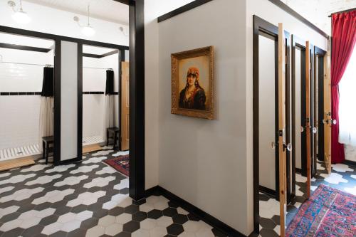 a hallway with a painting of a man on a wall at Beard and Lady Inn in Chester