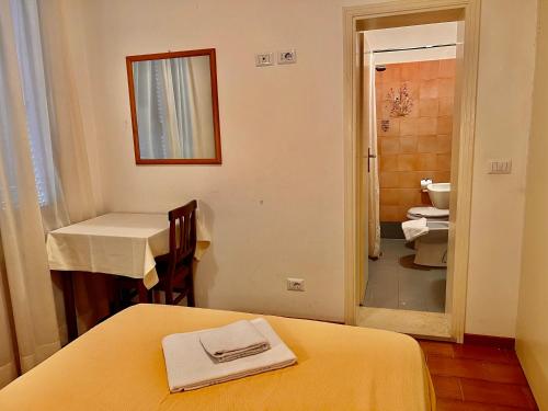 a bathroom with a bed and a sink and a toilet at Hotel Canada in Venice