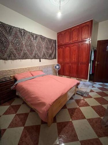 a bedroom with a large bed with a red comforter at Pearl in the Middle Atlas - ground floor in Azrou