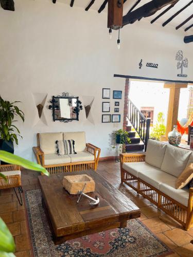 a living room with couches and a coffee table at Casa Real Barichara in Barichara