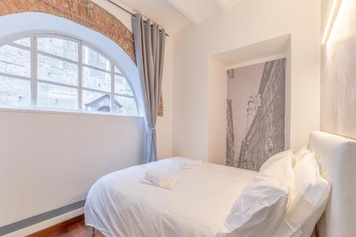 a bedroom with a white bed and a window at [Genova Centro] Colonna-Cattedrale di San Lorenzo in Genova