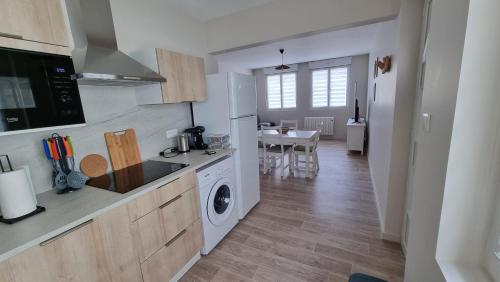 une cuisine avec lave-linge, sèche-linge et une table dans l'établissement Appartement RDC à 2 pas de la Plage et des commerces de BERCK PLAGE, à Berck-sur-Mer