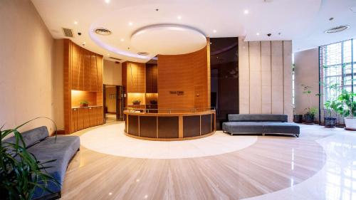 a lobby with a reception desk in a building at Holiday Inn Mudanjiang by IHG in Mudanjiang
