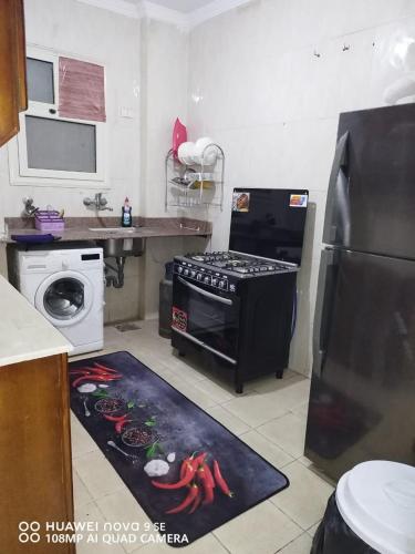 a kitchen with a stove and a sink and a refrigerator at 6 أكتوبر in 6th Of October
