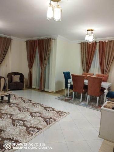 a living room with a table and chairs at 6 أكتوبر in 6th Of October