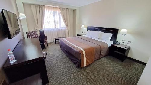 Una cama o camas en una habitación de Hotel Diego de Almagro Alto el Loa Calama