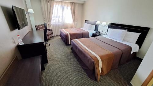 Una cama o camas en una habitación de Hotel Diego de Almagro Alto el Loa Calama