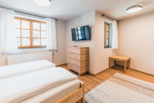 a bedroom with two beds and a tv at Felbermayer Appartements in Gaschurn